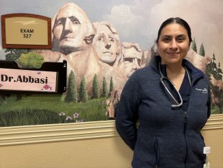 Dr. Denise Abbasi standing in front of her office